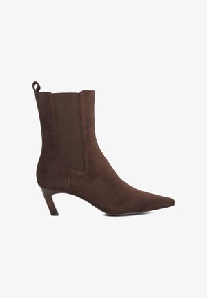 Brown suede ankle boot with a pointed toe, elastic side panels, and a low stacked heel. Smooth texture and sleek design.