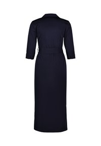 Vestido azul marino con cuello camisero, mangas tres cuartos, cintura ceñida con cinturón y una silueta larga y recta sin adornos visibles.