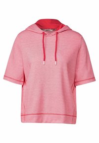 Kortærmet hættebluse i en levende pink nuance med en rød hætte. Har en struktureret tekstil, snoretræk og kontrasterende syninger i kanten.
