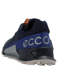 Navy blue athletic shoe with grey and black sole, blue heel panel with "ecco" branding, and brown pull tab on tongue.