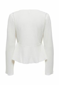 Haut peplum blanc à manches longues, en tissu texturé présentant un motif de froissement subtil, col rond et ourlet légèrement évasé.