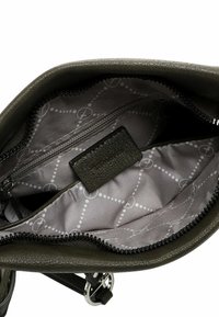 Olive green handbag with a textured exterior, zipper closure, and patterned gray lining featuring dots and interconnected shapes.