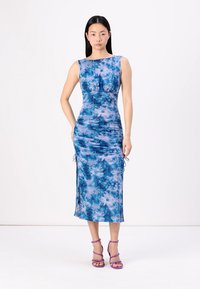 Robe à imprimé floral bleu avec une silhouette ajustée, sans manches et fronces sur les côtés. Fini avec des liens ajustables à l'ourlet.