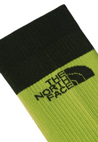 Grön och svart ribbad strumpa med "THE NORTH FACE"-logotypen i svart på den gr�öna delen. Mjuk textur med en tät passform.