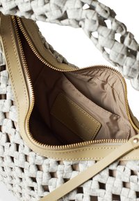 Woven light gray handbag with a beige trim and zipper, featuring a smooth interior lining and a label displaying "Borbonesse."