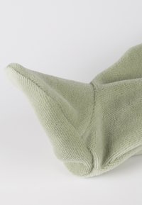 Green plush mitt with a triangular tip, soft texture, and stitched detailing. The material appears thick and cozy, designed for warmth.