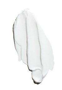 Dicke weiße Creme oder Paste, die in einem wellenförmigen, glatten Muster aufgetragen ist. Die Textur wirkt glänzend mit leichten Dellen auf der Oberfläche.