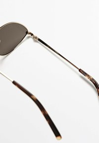 Aviator sunglasses with dark lenses, gold metal frames, and brown tortoise-shell patterned arms, featuring engraved detailing on the temples.