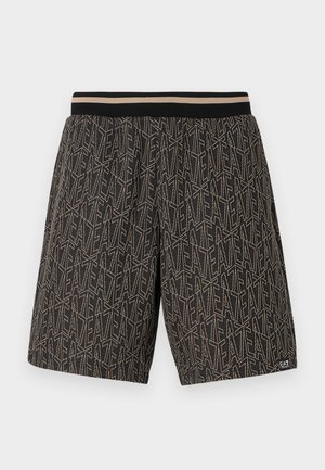 Zwarte shorts met een gestructureerd patroon van diagonale lijnen en de tekst "EAT" in beige. Elastische tailleband met contrasterende strepen.