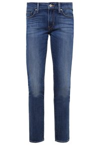 Slim fit modré džíny s pěti kapsami, zapínáním na knoflík a mírným opotřebením na stehnech a kolenou.