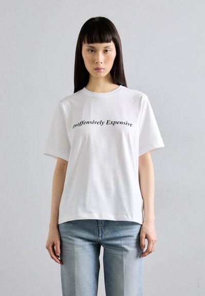Tricou din bumbac alb cu mâneci scurte, guler la baza gâtului și text negru care spune "inoffensively Expensive" într-o font casual.