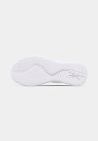 White athletic shoe sole with textured rubber, featuring a wave pattern and small circular grips for traction. Minimalist design with logo detail.