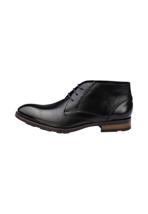 Black leather ankle boot with three eyelet laces, brown stacked heel, and rubber sole, shown in side profile on white background.