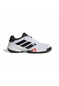 White athletic shoes with black accents, textured mesh upper, three black stripes, red detail on the side, and a rubber sole.