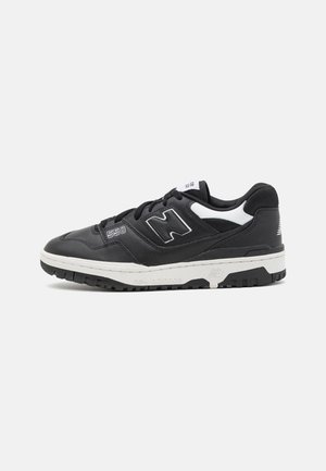 Basket New Balance 550 noir et blanc avec fermeture à lacets, semelle en caoutchouc et étiquette "550" sur le côté, vue de l'extérieur.