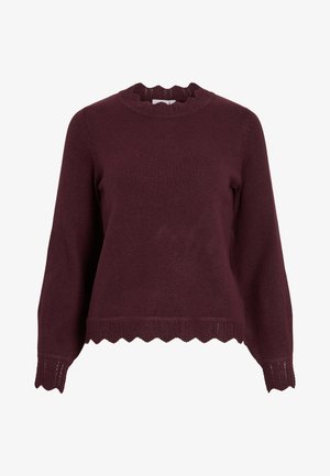 Burgunderrød strikket genser med lange ermer, scalloped utringing og teksturert kant med zigzag-mønster. Mykt materiale, figursydd design.