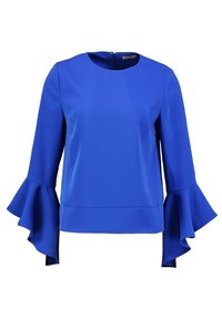 Niebieska bluzka z długim rękawem wykonana z gładkiego materiału. Posiada okrągły dekolt oraz rozkloszowane mankiety z warstwowym wykończeniem. Zapinana z tyłu na suwak.