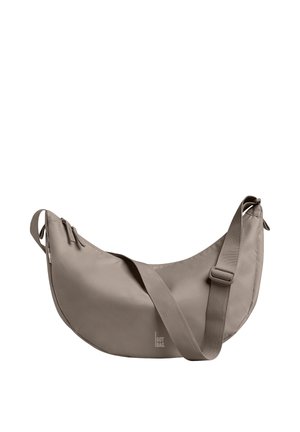 Light brown crescent-shaped crossbody bag with adjustable strap and zipper closure, labeled "GOT BAG" on front center.