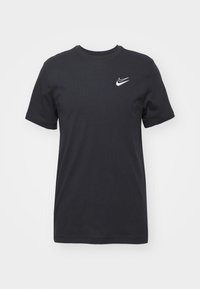 Black cotton t-shirt with short sleeves, crew neck, and white Nike logo on the upper left chest area. Smooth texture, casual design.