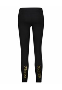 Black leggings made of stretchy fabric with a high waistband. Features bold gold text on the lower legs. Smooth texture, fitted design.