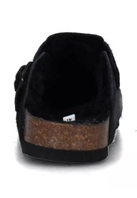 Pantofole nere con tomaia texturizzata, suola in sughero e forma arrotondata. Interno foderato con materiale morbido per comfort.