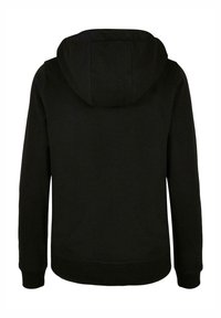 Must pusa, mille varrukatega ja taskuga. Valmistatud pehmest kangast, lihtsa, ilma õmblusteta disainiga ja ribadega mansettidega.