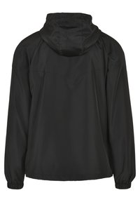Veste noire à capuche avec manches longues et poignets élastiques vue de dos sur un fond blanc uni.