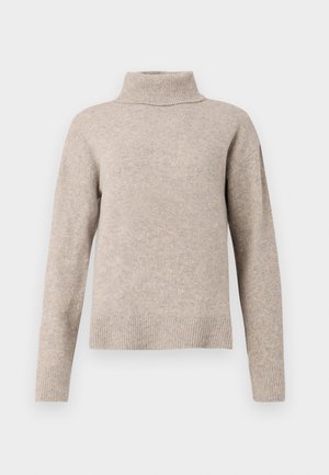 Beige høyhalset genser laget av mykt strikkemateriale. Har en ribbestrikket krage og mansjetter, med en litt oversized, avslappet passform.