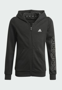 Felpa nera con zip realizzata in tessuto morbido, dotata di tasche frontali, cappuccio e logo Adidas bianco con branding sulla manica.