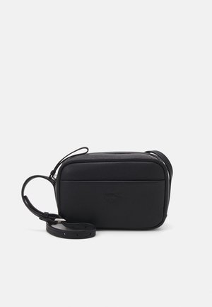 Černá kožená obdélníková crossbody taška s nastavitelným popruhem a jemným raženým logem na přední kapse.