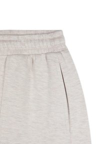 Pantaloni della tuta grigio chiaro con vita elastica a costine, tasche laterali e un tessuto morbido e testurizzato con un delicato motivo mélange.