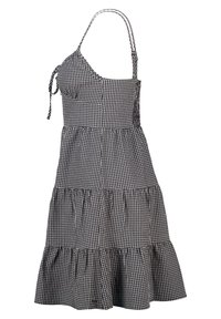 Black and white gingham print dress with adjustable straps, fitted bodice, tiered ruffled hem, and lightweight fabric texture.