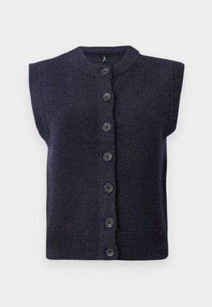 Cárdigan sin mangas de un oscuro tono azul marino con un escote redondo, que presenta seis botones negros en el centro y detalles de ribete en el dobladillo. Textura suave.