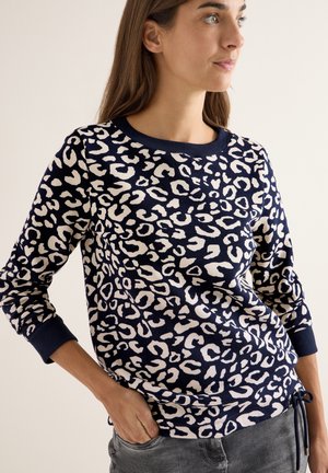 Pullover-Sweatshirt in Marineblau mit einem weißen Leopardenmuster. Verfügt über einen runden Ausschnitt, lange Ärmel mit gerippten Bündchen und einem Kordelzugsaum.