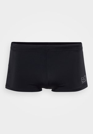 Calções de banho pretos feitos de um tecido suave com um design ajustado, apresentando um logótipo na lateral e costura sem emendas para conforto.