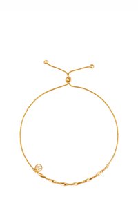 Złota bransoletka o skręconym wzorze z regulowanym zapięciem. Posiada gładką fakturę oraz dwa okrągłe akcenty.