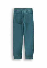 Turkusowe dresy z ribbami przy nogawkach i w pasie, z dwoma tylnymi kieszeniami. Wykonane z miękkiego, strukturalnego materiału.