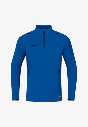 Haut zippé bleu de sport avec des manches longues, fabriqué en tissu évacuant l'humidité. Présente des accents noirs et le logo "JAKO" sur le devant.