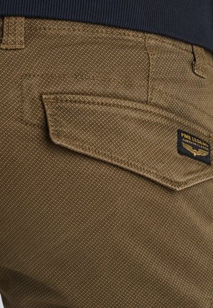 Pantalones marrones con textura, con un bolsillo trasero distintivo y una etiqueta PME Legend. La tela tiene un patrón sutil y detalles de costura visibles.