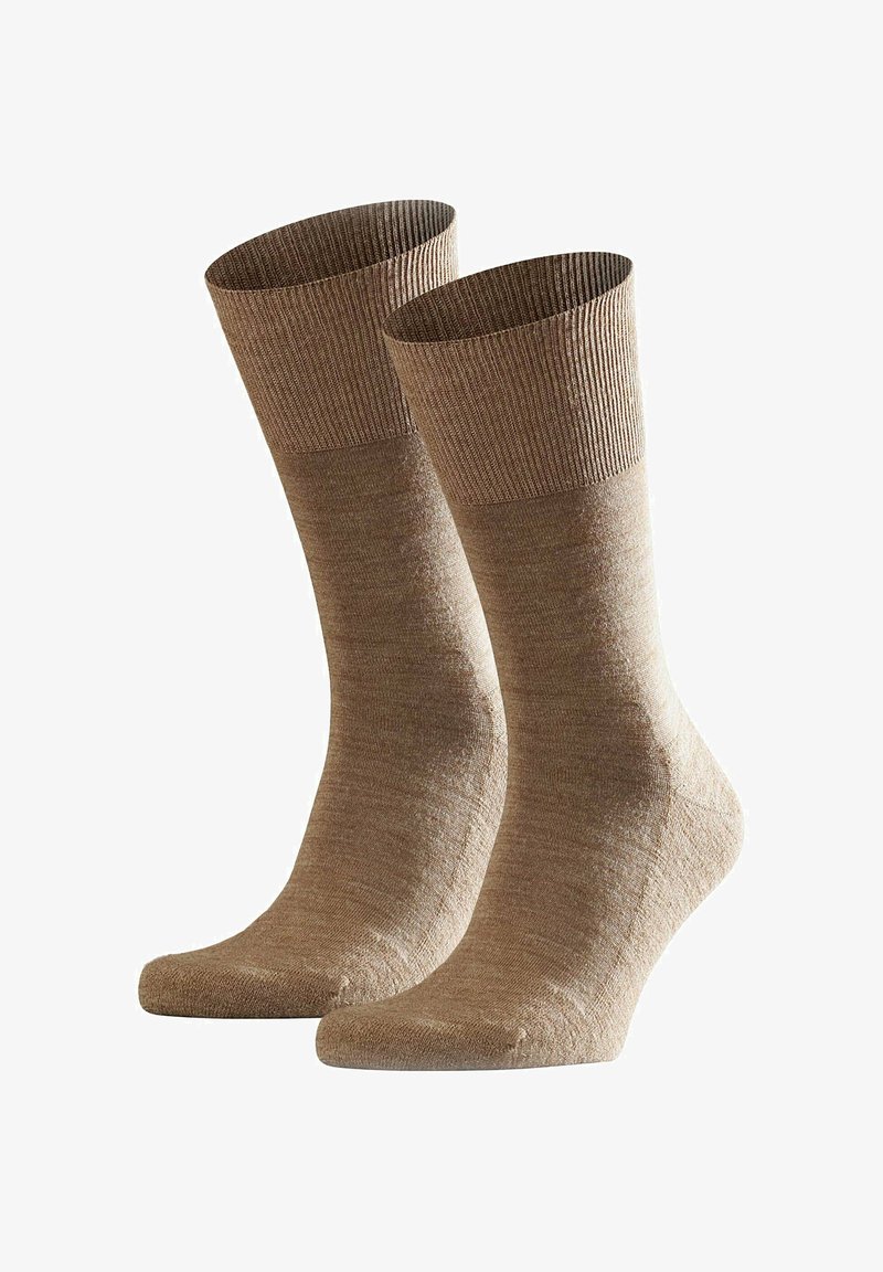 Calzini marroni con polsino a coste, realizzati in un materiale morbido e testurizzato. Presentano un corpo liscio e una punta e un tallone leggermente più chiari.