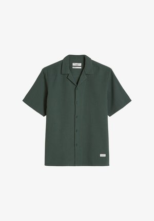 Dark green short-sleeve button-up shirt with camp collar and small white label near the hem, laid flat on a white background.