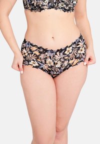 Bloemenkant slip met een zwarte basis en meerkleurige bloempatronen. Golfvormige randen en een zachte textuur verbeteren het ontwerp.
