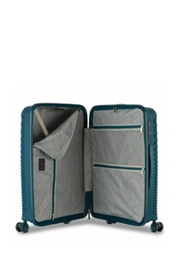 Valigia rigida blu con struttura testurizzata, dotata di interno grigio, tasche con zip e lucchetto a combinazione. Ruote girevoli doppie.