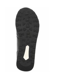 Semelle de chaussure en caoutchouc noir avec une surface texturée présentant des pics antidérapants triangulaires et un accent blanc lisse au centre.