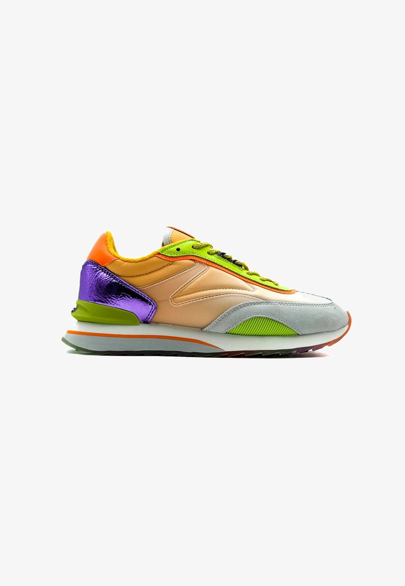 Multicolored sneaker featuring a beige upper, purple heel accent, green laces, and a textured gray toe cap with an orange outsole.