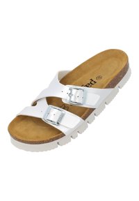 Vit halkskyddssandal med två justerbara silverfärgad spännen. Har en strukturerad brun fotbädd och en tjock vit gummisula med ett mönster.