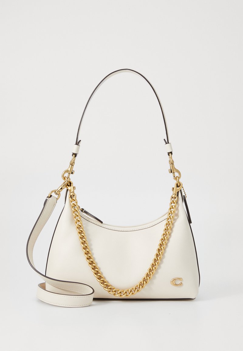 White leather handbag with a curved shape, gold chain accent, and a detachable shoulder strap. Features a logo detail on the side.