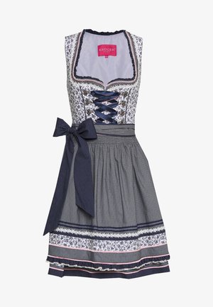 Biała i granatowa sukienka dirndl bez rękawów z kwiatowym wzorem, granatowym gorsetem z sznurowaniem oraz pasującym fartuchem związanym dużą kokardą w groszki.