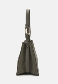 Olive green leather handbag with a structured triangular shape, adjustable strap, and gold-tone hardware detail. Textured surface.