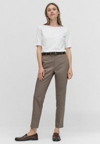 White short-sleeve t-shirt, brown tailored pants, black belt, and dark brown loafers. Smooth fabric, fitted design, and straight cut.